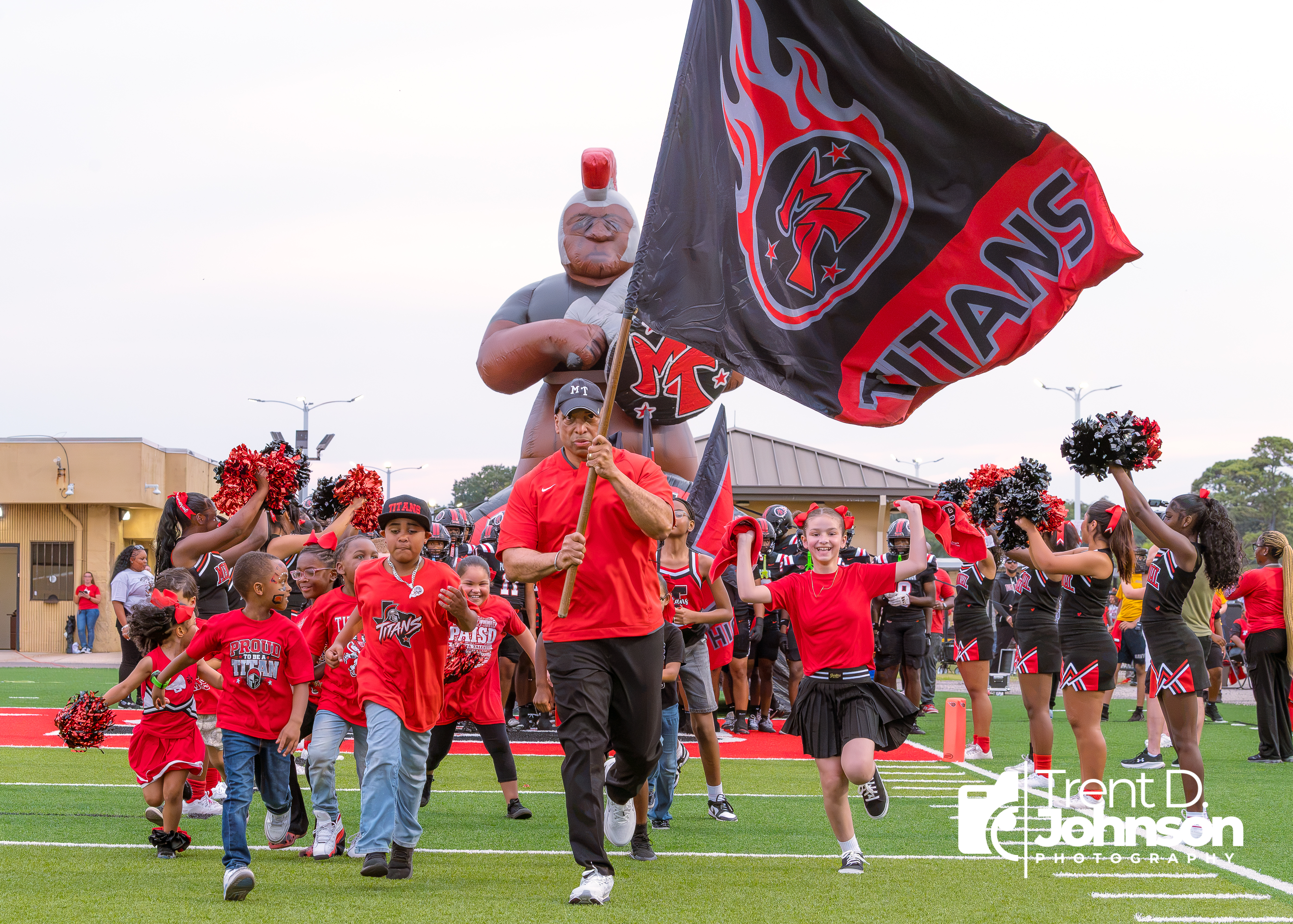 PAISD Superintendent Dr. Mark Porterie leads Titan Nation onto the football field to start the Friday Night Lights experience.